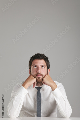 Portrait of a young businessman thinking.