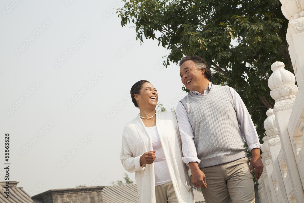 Senior couple walking outside in Beijing, tilt Senior couple walking outside in Beijing, tilt