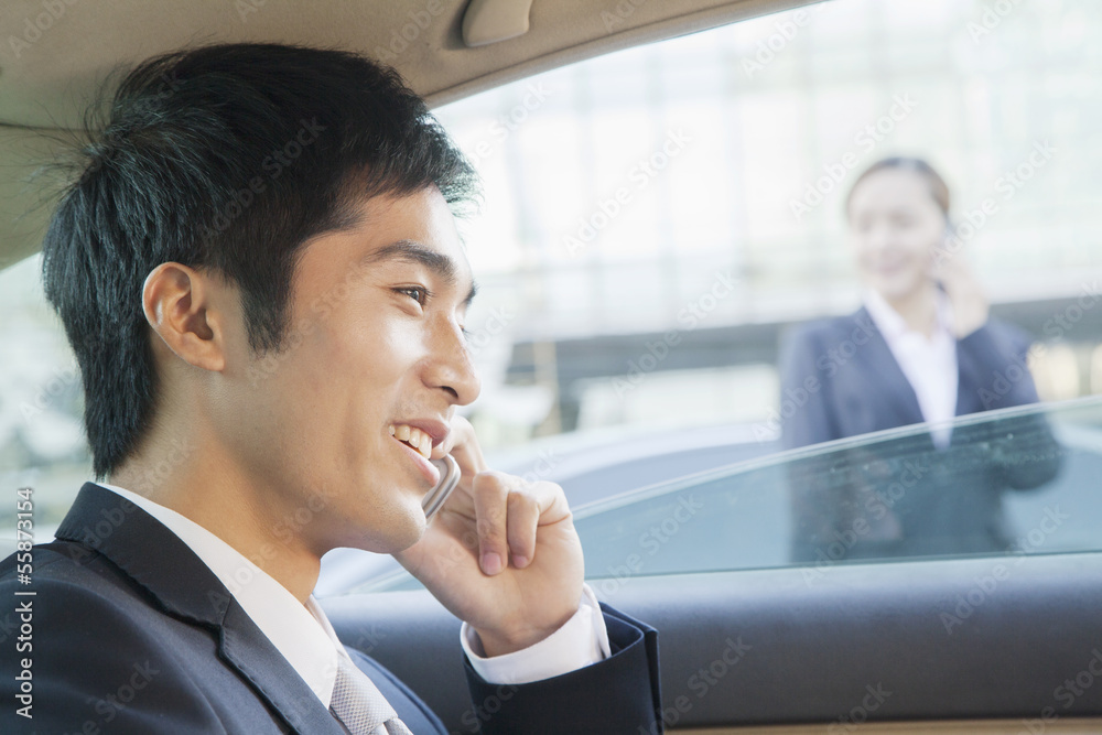 Businessman in Back Seat of Car on the Phone, Close Up