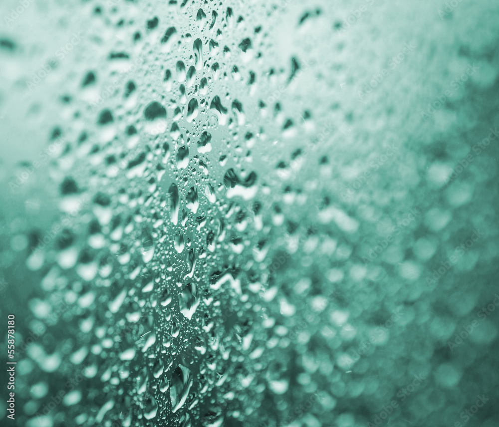Drops on a glass with selective focus. Emerald toned image. Drops on a glass with selective focus. Emerald toned image.