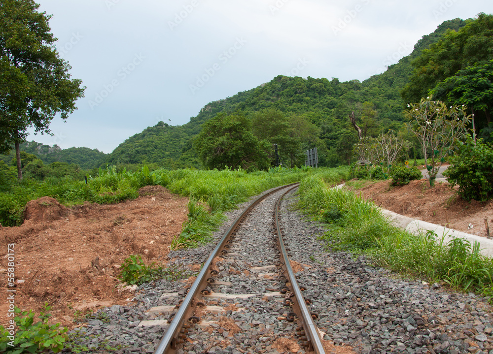 Fototapeta premium Train tracks curving along a mountain