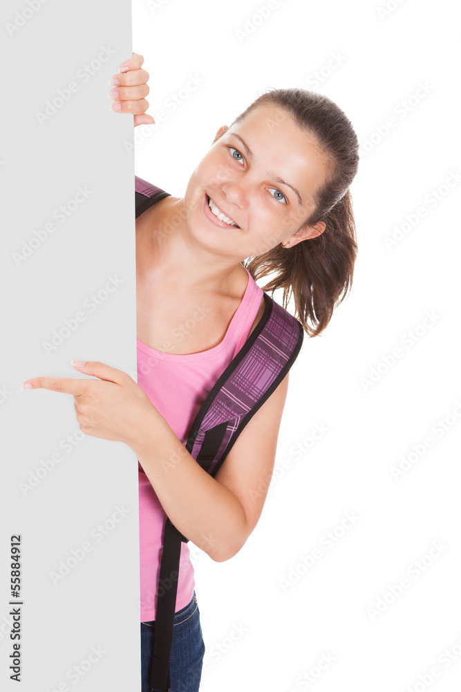 Female student pointing on placard Female student pointing on placard