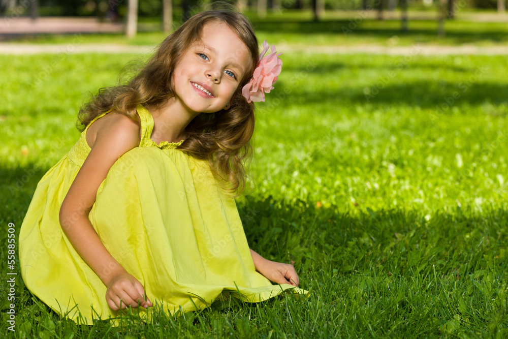 Smiling young girl on the grass