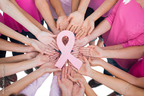 Obraz na plátně Hands joined in circle holding breast cancer struggle symbol