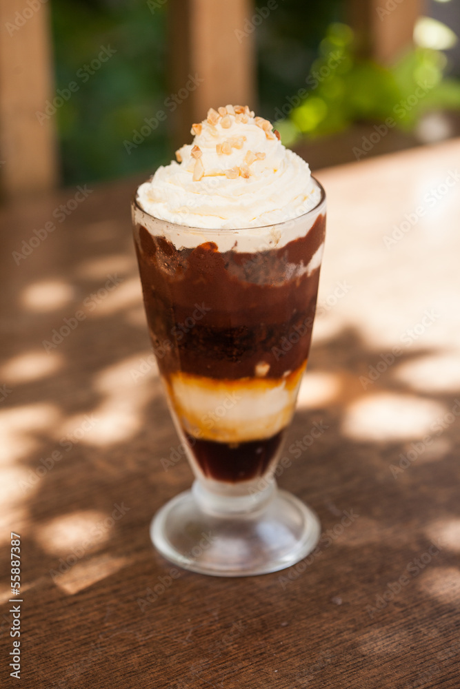 Chocolate sundae with whipped cream and chopped nuts Chocolate sundae with whipped cream and chopped nuts