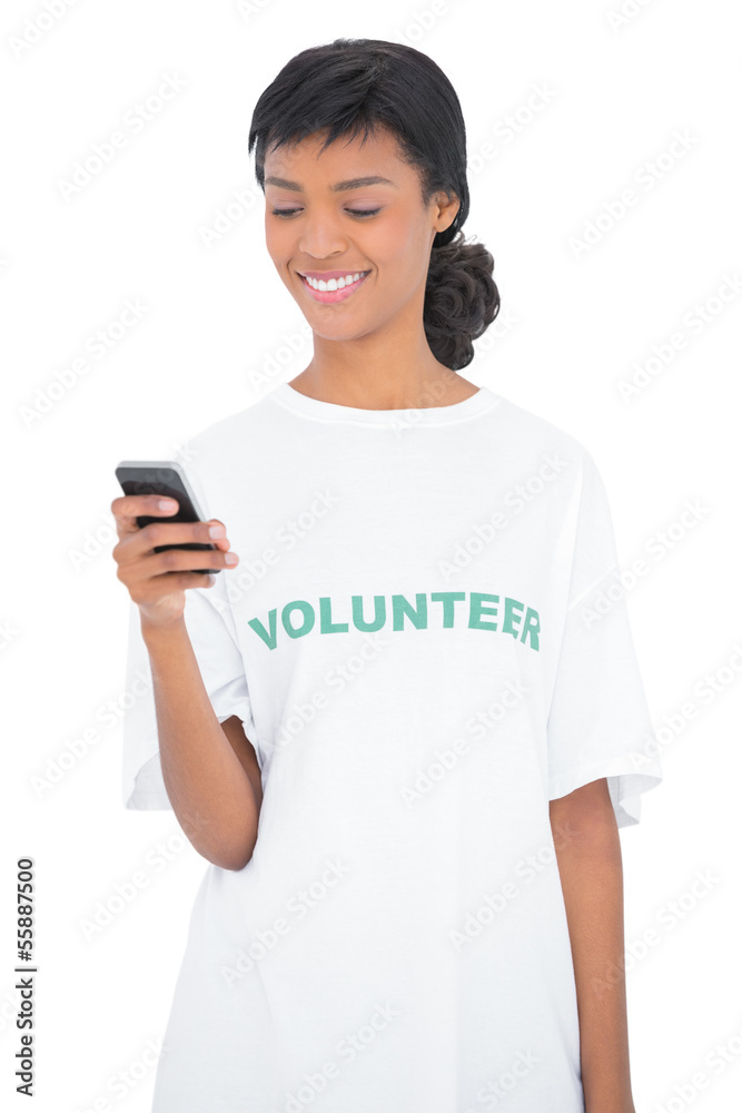 Pretty black haired volunteer texting with her mobile phone