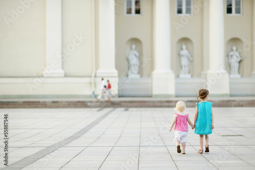 Two little sisters walking together © MNStudio