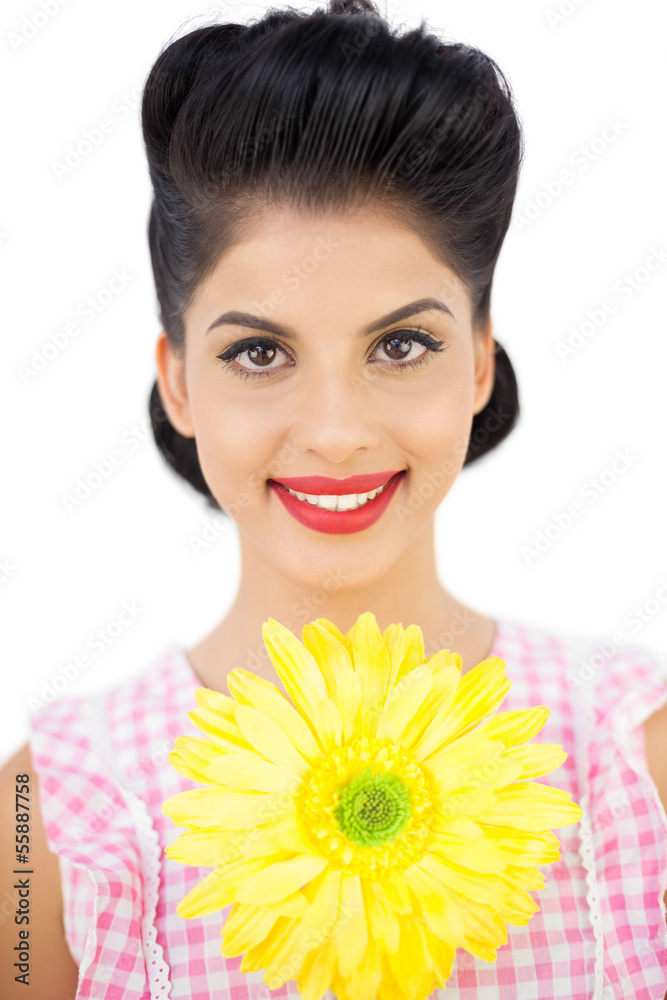 Smiling black hair woman showing a flower
