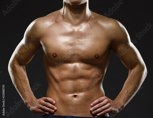 Close up of sexy male's chest, isolated on black