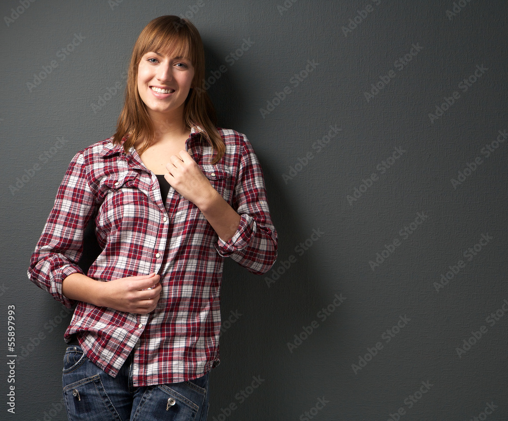 Portrait of a young woman smiling on gray background Portrait of a young woman smiling on gray background