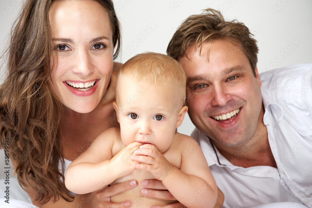 Portrait of a happy family smiling with baby Portrait of a happy family smiling with baby