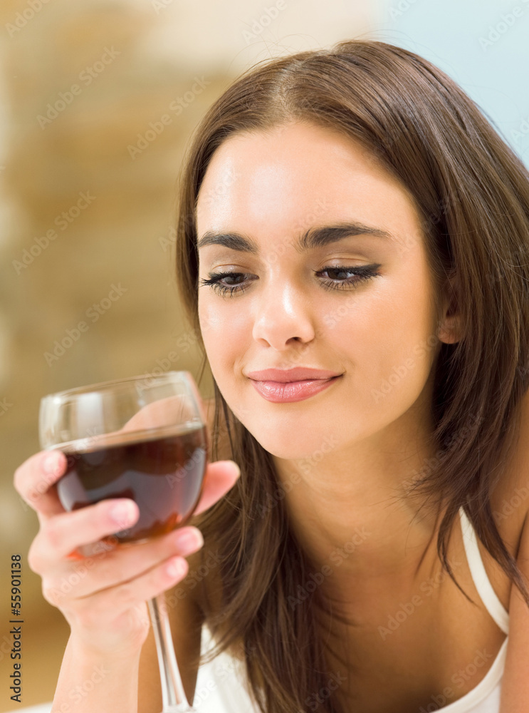 Young woman with glass of redwine Young woman with glass of redwine