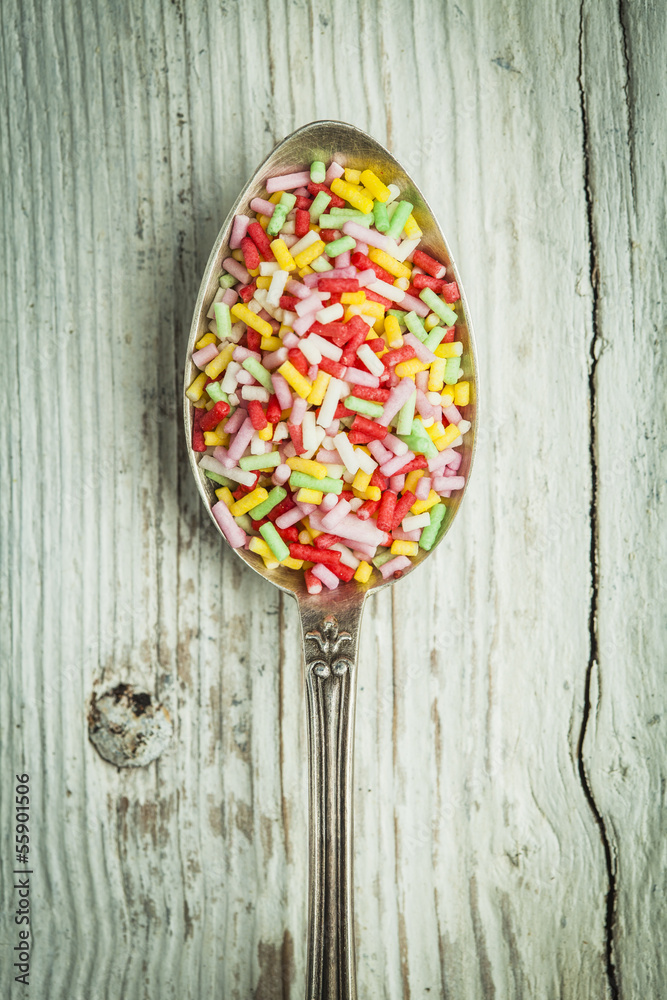 Spoon with sugar little candies