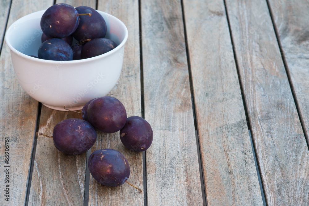 Arrangement of damson plums on wooden boards Arrangement of damson plums on wooden boards