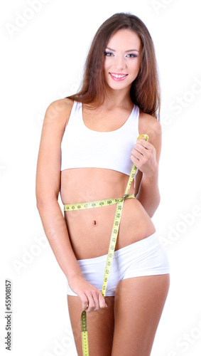 Beautiful young woman measu...