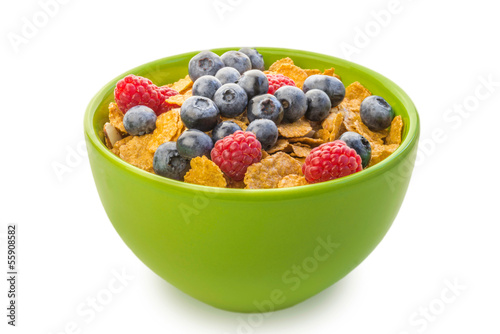 A bowl of cereal with raspberries and blueberries