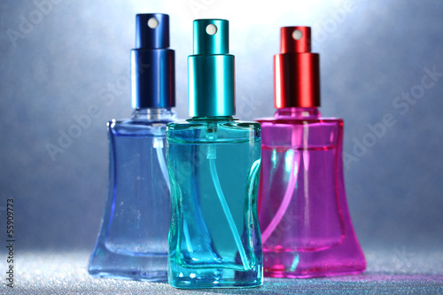 Women perfume in beautiful bottles on bright background