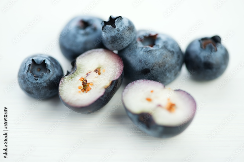 Horizontal shot of whole and halved blueberries, macro Horizontal shot of whole and halved blueberries, macro