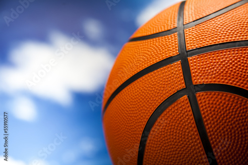 Basketball ball over blue sky background 
