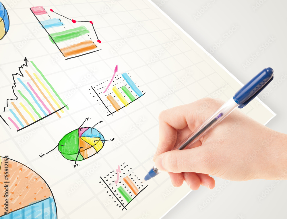 Business person drawing colorful graphs and icons on paper
