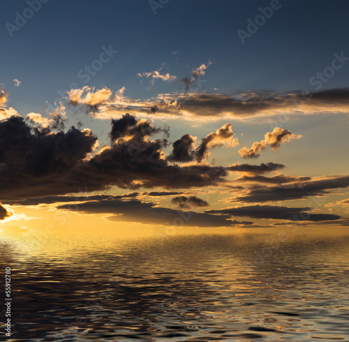 Sunset with clouds reflected in water. © Vladimir Arndt