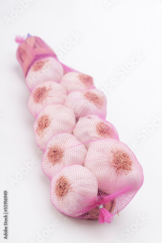 heads of garlic tied in a row and sheathed in a net