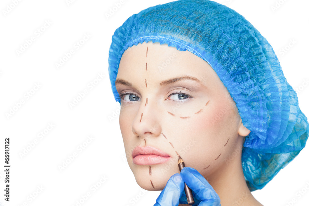 Surgeon drawing dotted lines on content patient Surgeon drawing dotted lines on content patient