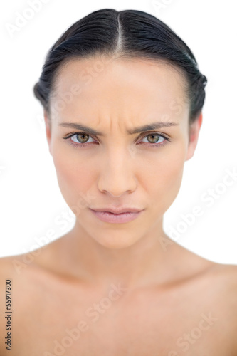Frowning brunette posing in close up