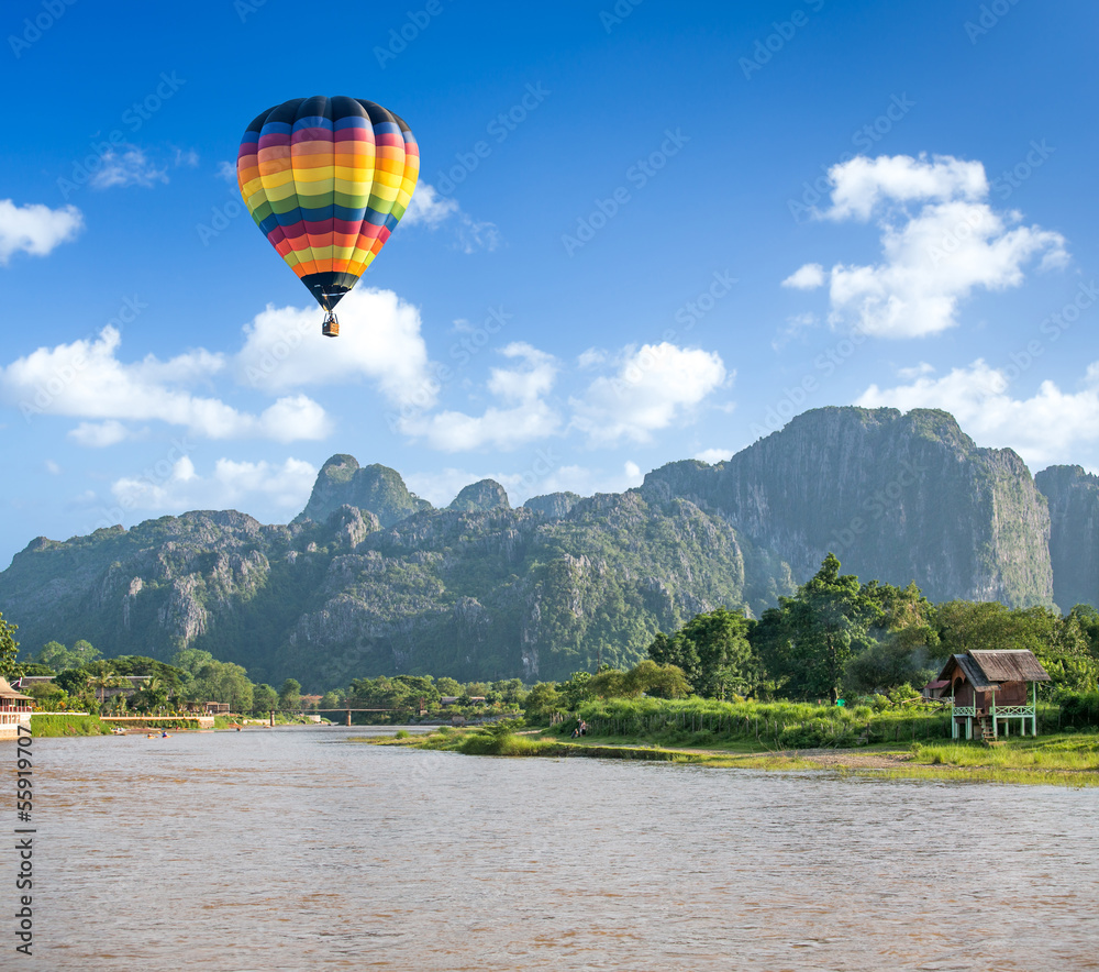 Fototapeta premium Colorful hot air balloon over Song river Vang Vieng, Laos