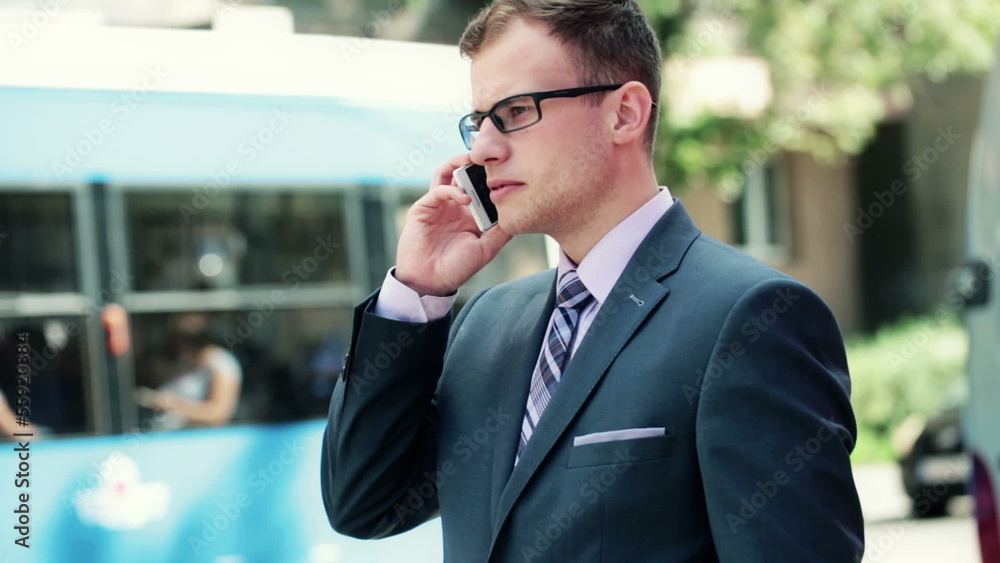Young handsome businessman talking on mobile phone in the city Young handsome businessman talking on mobile phone in the city