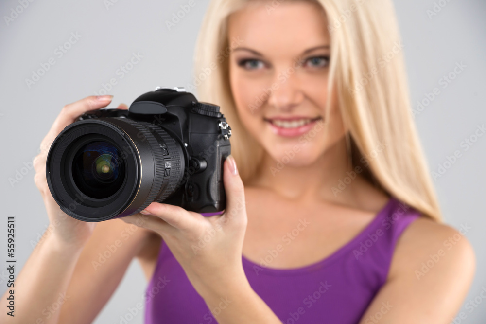 Women with camera. Side view of cheerful young women holding cam Women with camera. Side view of cheerful young women holding cam