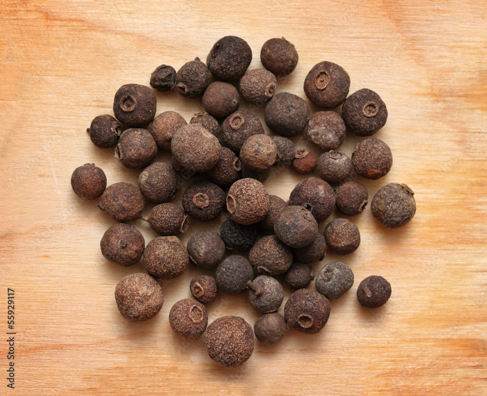 pimento peppercorns macro on wooden board pimento peppercorns macro on wooden board