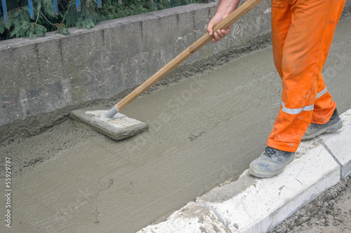 Worker leveling fresh Concrete