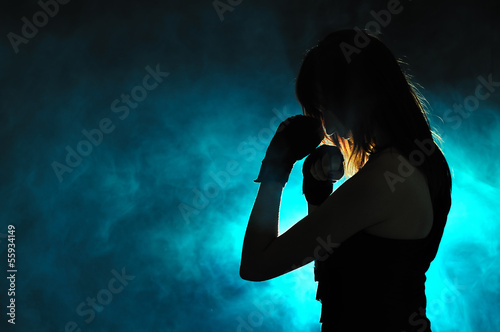 Silhouette of the girl in boxing pose