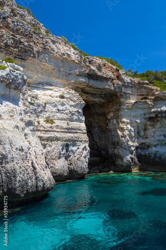 Pirate coast cliff cave at Menorca island, Spain. © tuulijumala