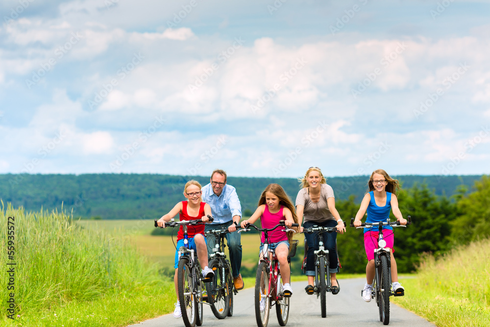 Fototapeta premium Family cycling in summer in rural landscape