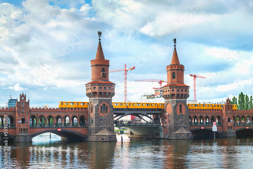 Oberbaum bridge, train and river Spree in Berlin, Germany