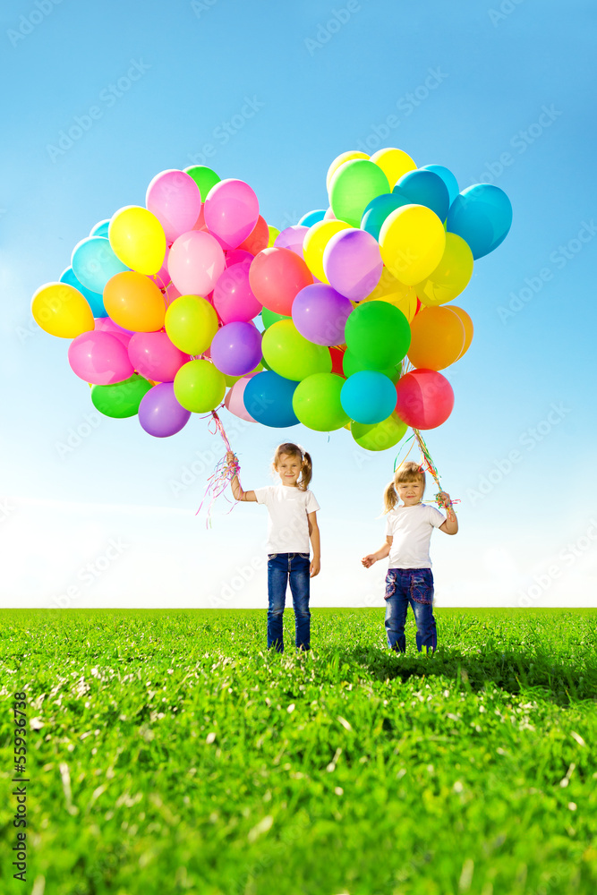 Happy family holding colorful balloons. Mom, dad and two daughte Happy family holding colorful balloons. Mom, dad and two daughte