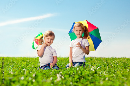 Two little girls in outdoor park at sunny day. Sisters in the