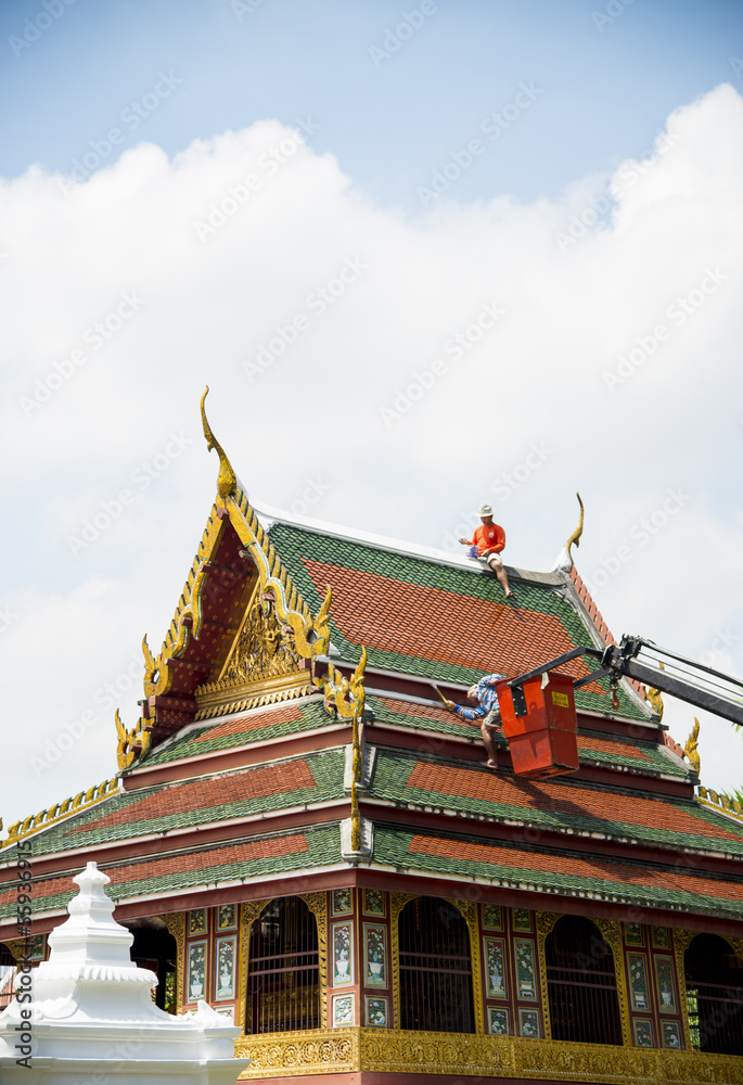 Men repair roof of Temple4
