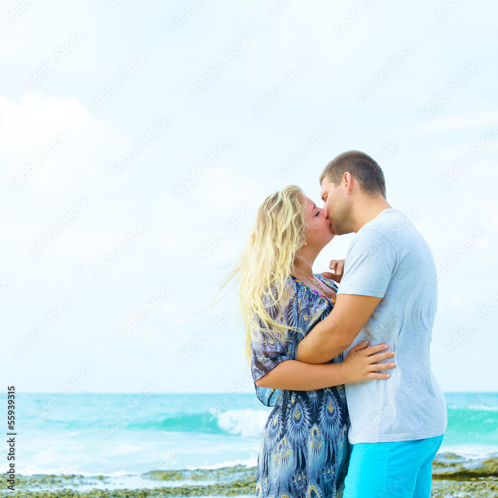 couple in love kissing on the beach at summer time couple in love kissing on the beach at summer time