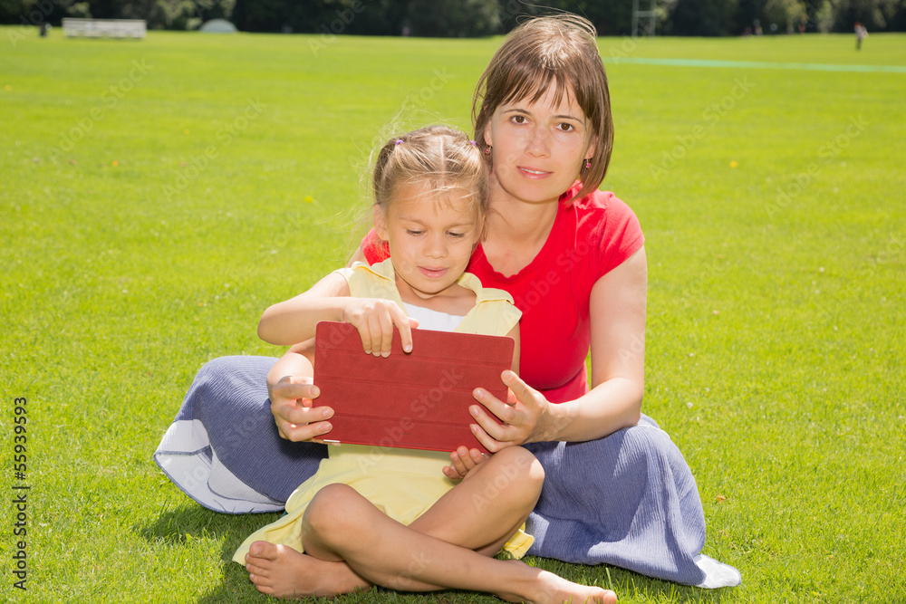 A Girl and Her Mother With Tablet Computer A Girl and Her Mother With Tablet Computer