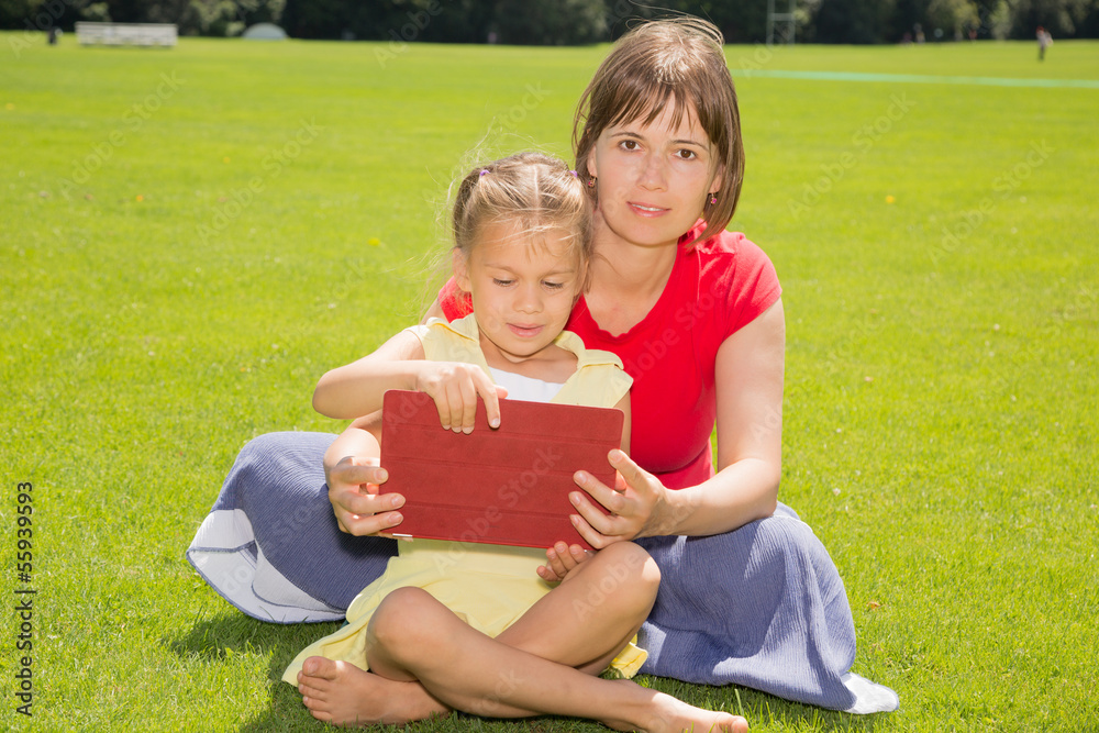 A Girl and Her Mother With Tablet Computer