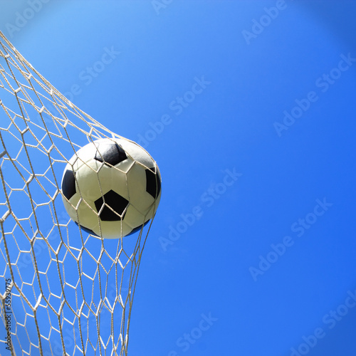 Soccer ball in goal, success concept