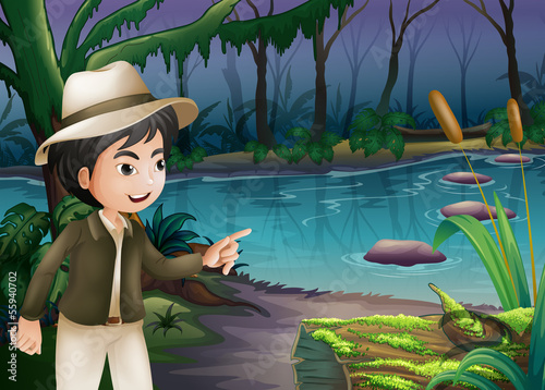 A young boy pointing the log with algae