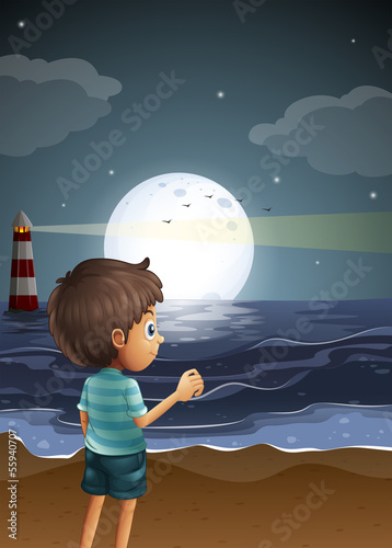 A beach with a young boy