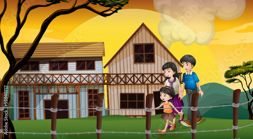 A family walking in front of the wooden houses