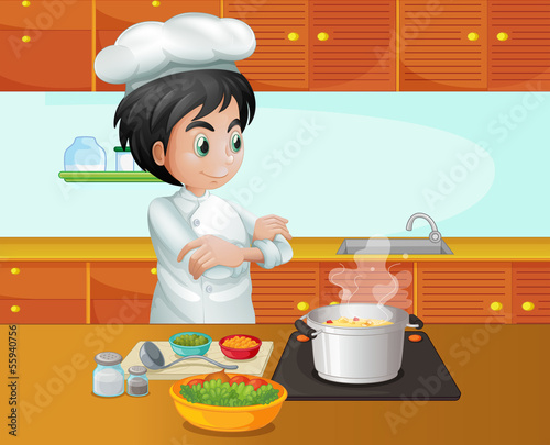 A male chef cooking at the kitchen