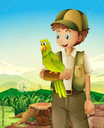 A boyscout holding a parrot