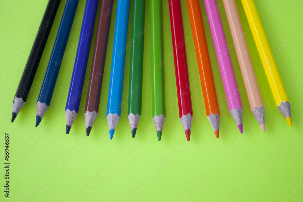 Colored pencils on a green background Colored pencils on a green background